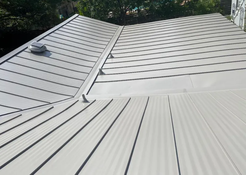 Solar attic fan installed on a metal roof for Roof Ventilation in Brunswick